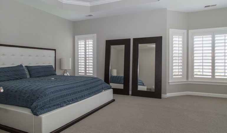 Polywood shutters in a minimalist bedroom in Charlotte.